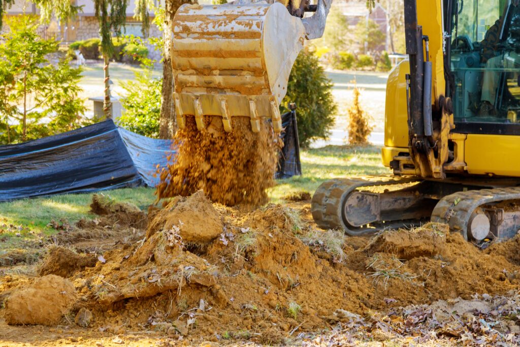 Excavator machine unloading soil earth moving construction works